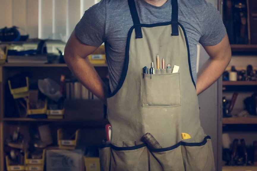 Man wearing apron with tools