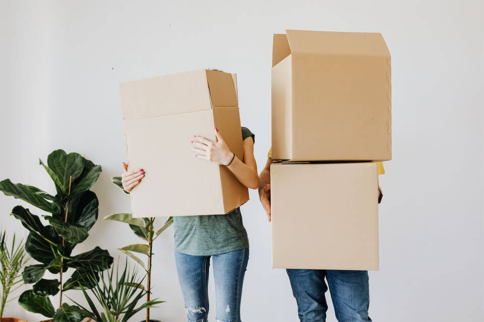 People holding moving boxes