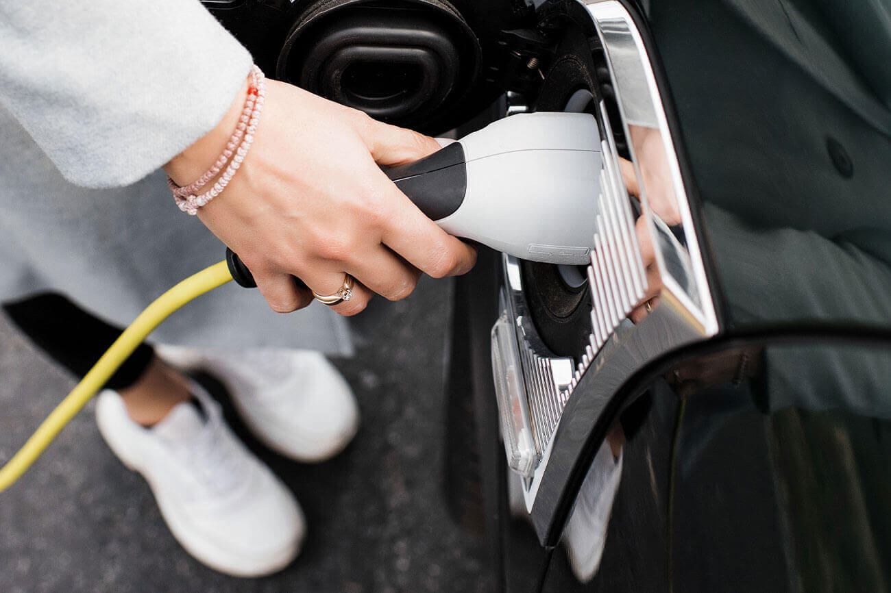 Photo of person charging their electric vehicle